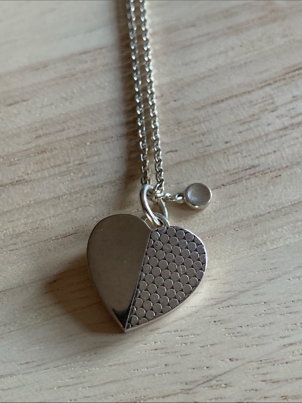 MOVADO silver heart pendant in excellent condition with claw clasp